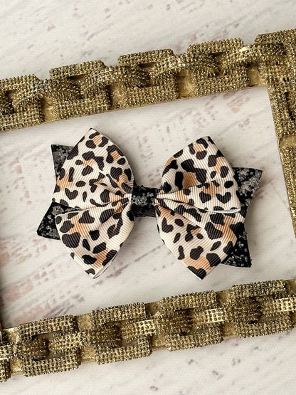 Animal print and black glitter hair bow on single alligator clip