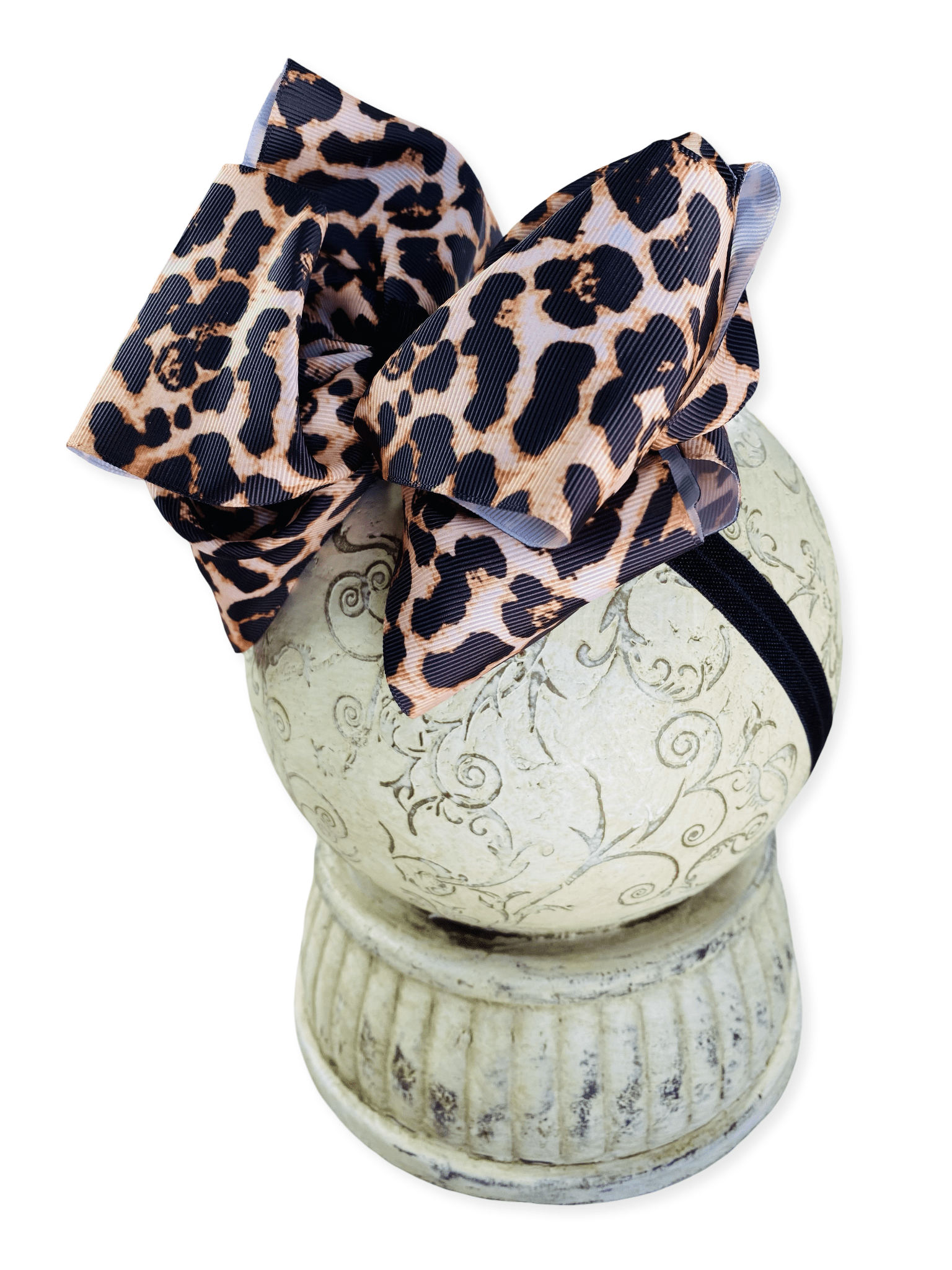 Leopard print bow on a decorative white pedestal