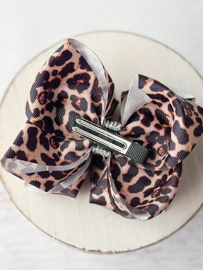 Back of leopard print hair bow showing double prong alligator clip