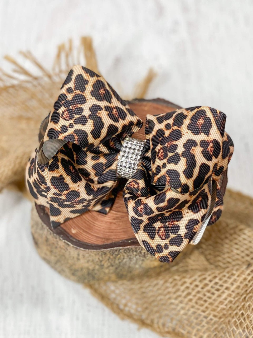 Leopard print 4 inch hair bow with rhinestone center on alligator clip
