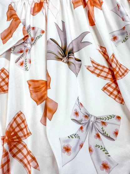 close up pf the bow pattern on dress
