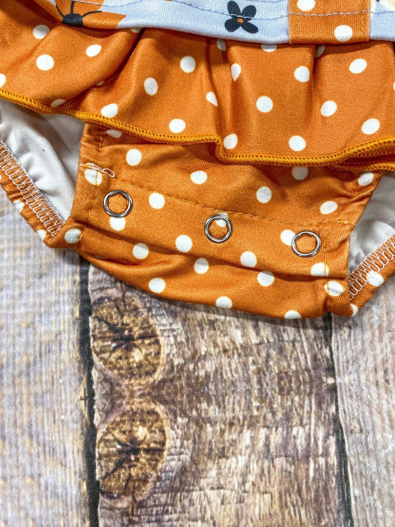 close up photo of the snaps at bottom of romper