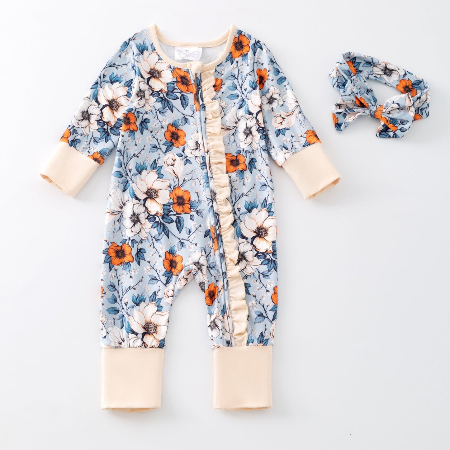 Floral baby onesie and headband on a white background