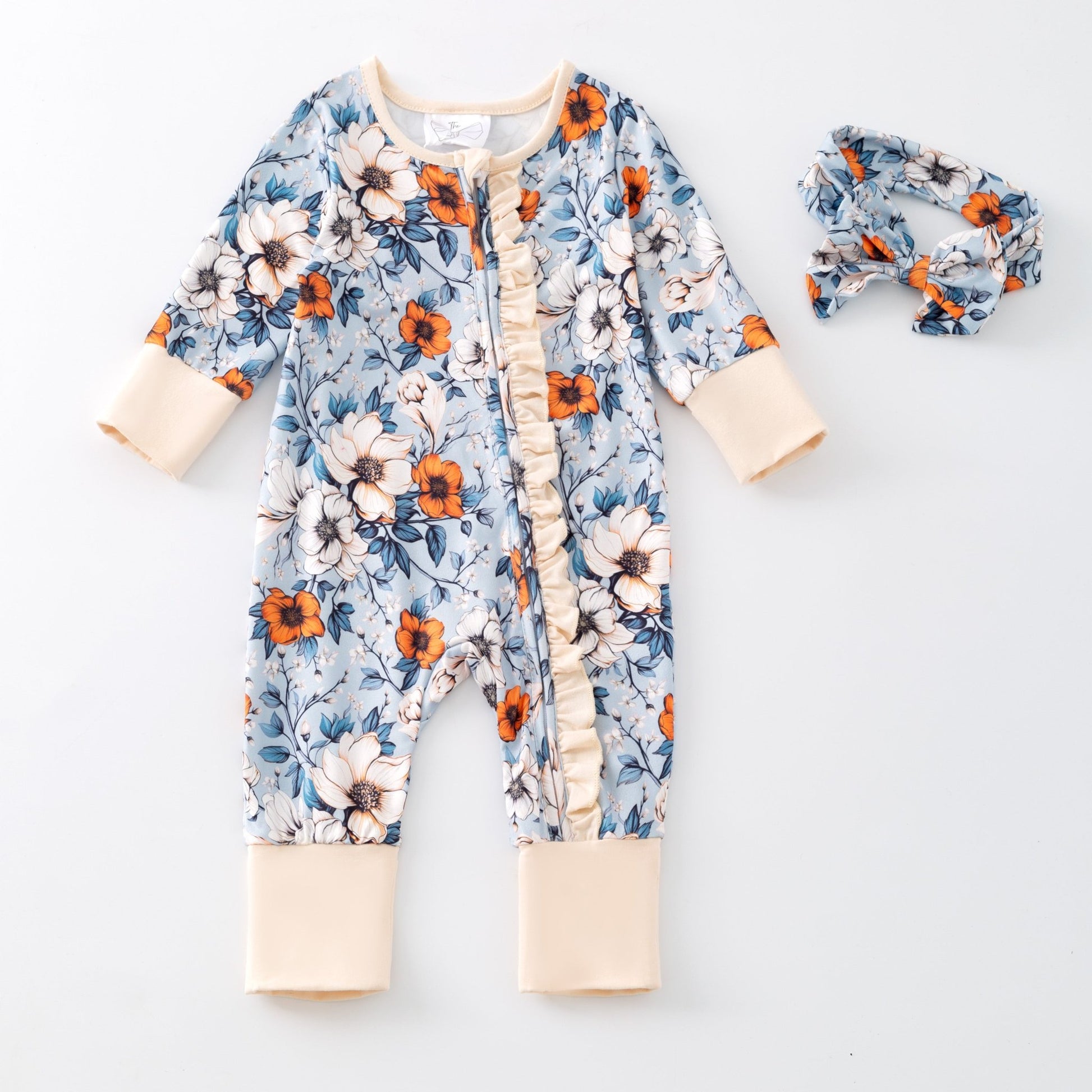 Floral baby onesie and headband on a white background