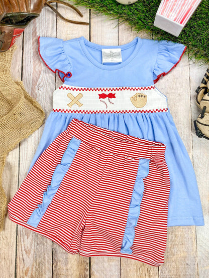 baseball smocked outfit on wood surface