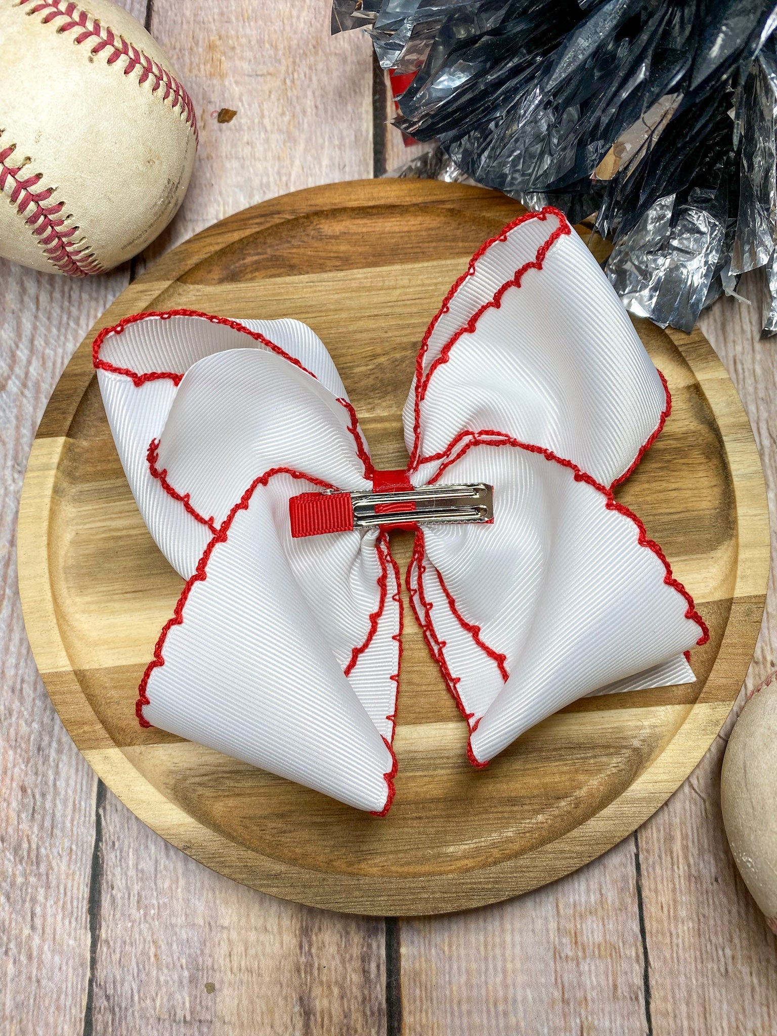 red and white baseball embroidered headband on a wooden background