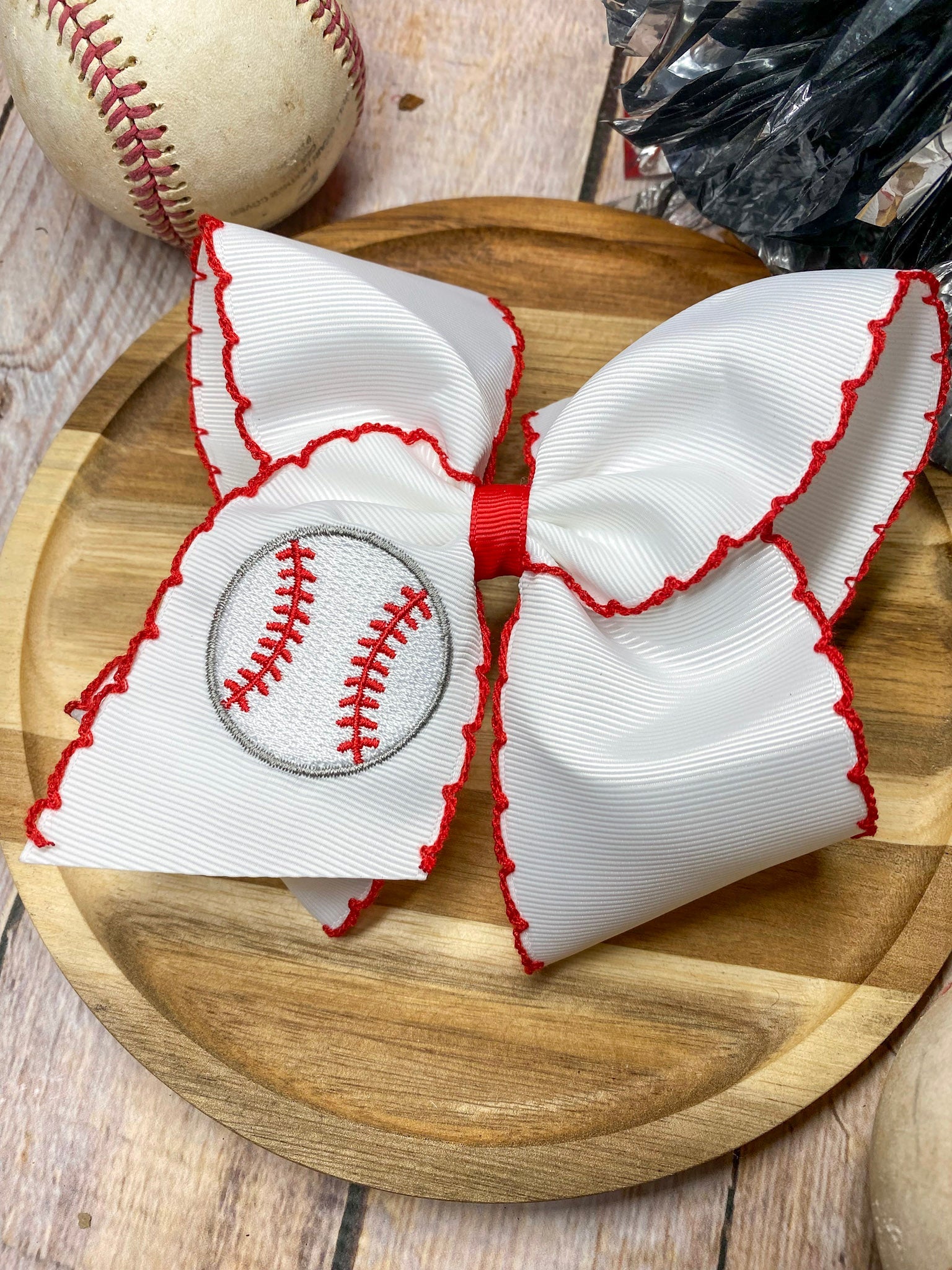 red and white baseball embroidered headband on a wooden background
