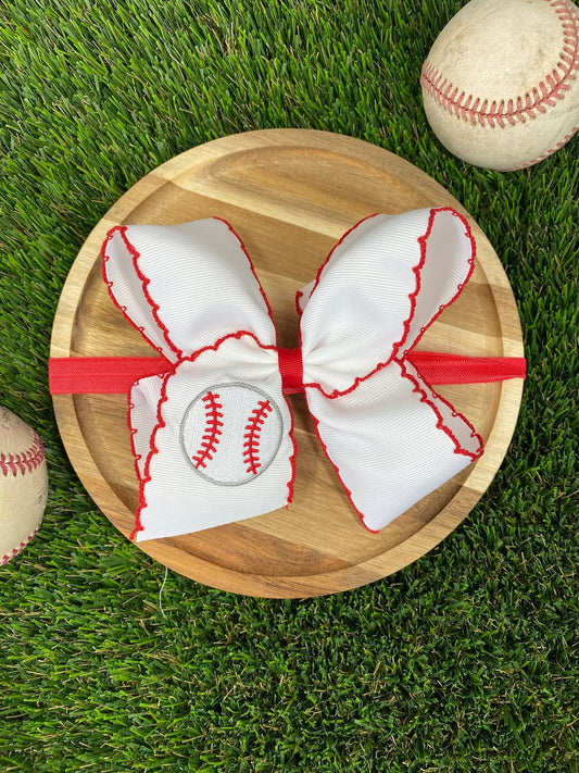 Red and white baseball moonstitch embroidered bow on grass - Alternative view