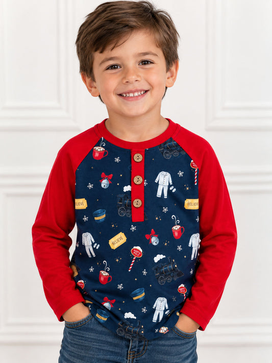 model wearing Boys Christmas train print raglan shirt with red long sleeves and wooden buttons