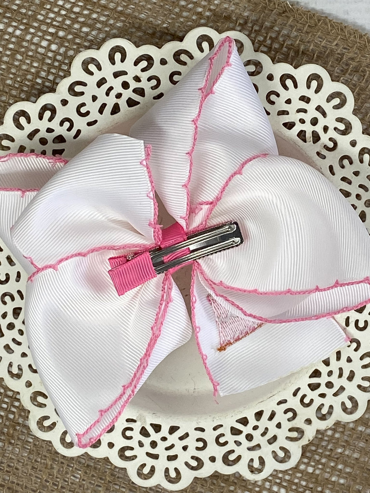 Back of birthday cake embroidered moonstitch hair bow showing alligator clip