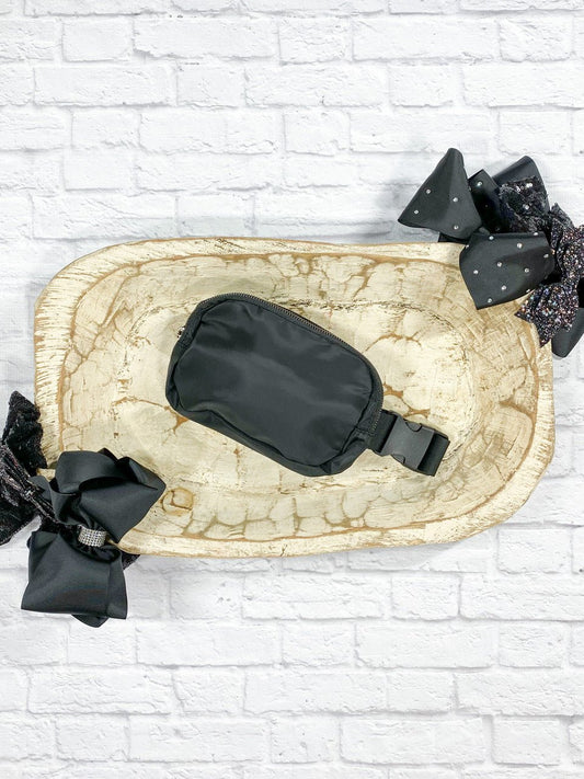 Black belt bag with a zip front and adjustable strap
