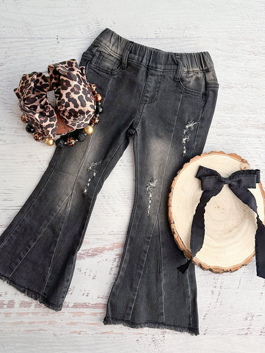 Black distressed flare jeans with a leopard headband