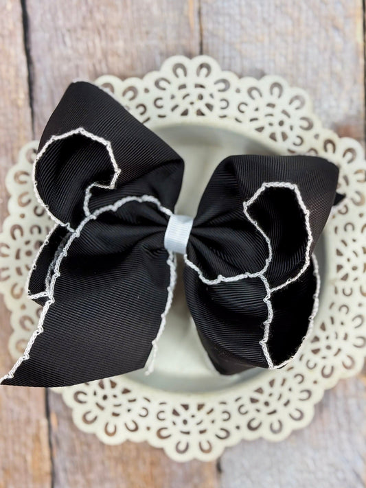 black grosgrain hair bow with white moonstitch edging