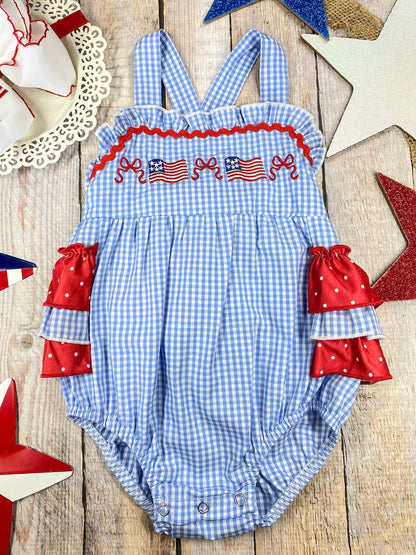 Smocked Flag Gingham Bubble Romper on a wooden background 