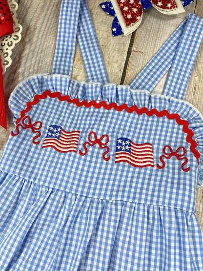  Smocked Flag Gingham Tiered Dress on a wooden background