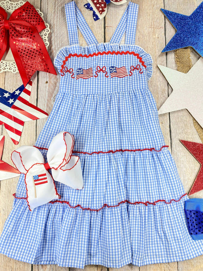  Smocked Flag Gingham Tiered Dress on a wooden background