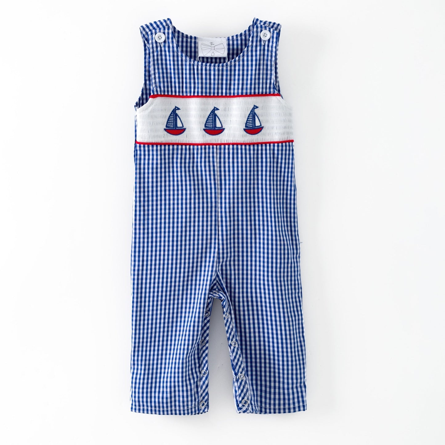 Blue checkered romper with sailboat design on a white background