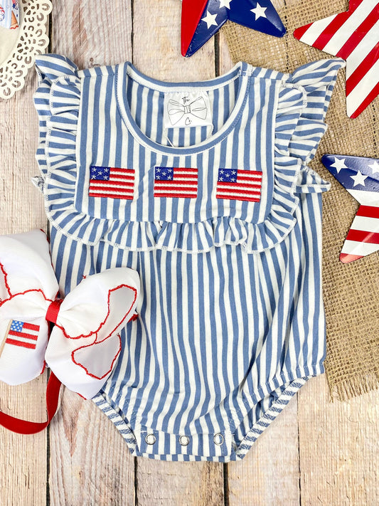 Flag Stripe Bubble Romper on a wooden background