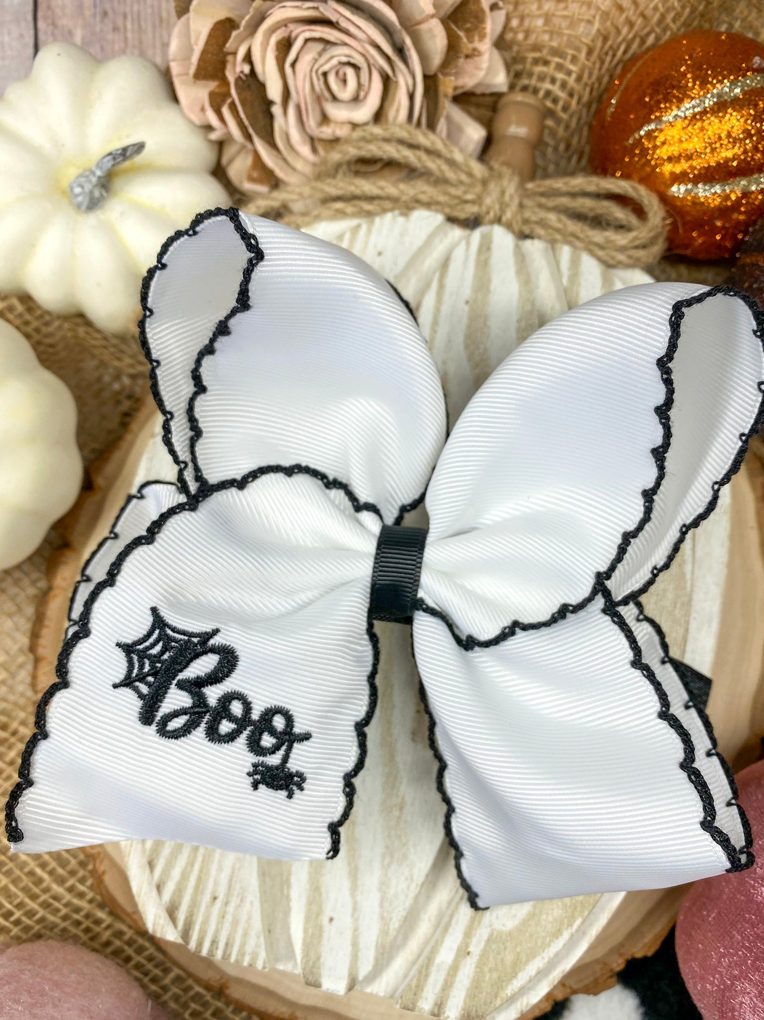 Black and White Boo Halloween Hair Bow on a wooden background