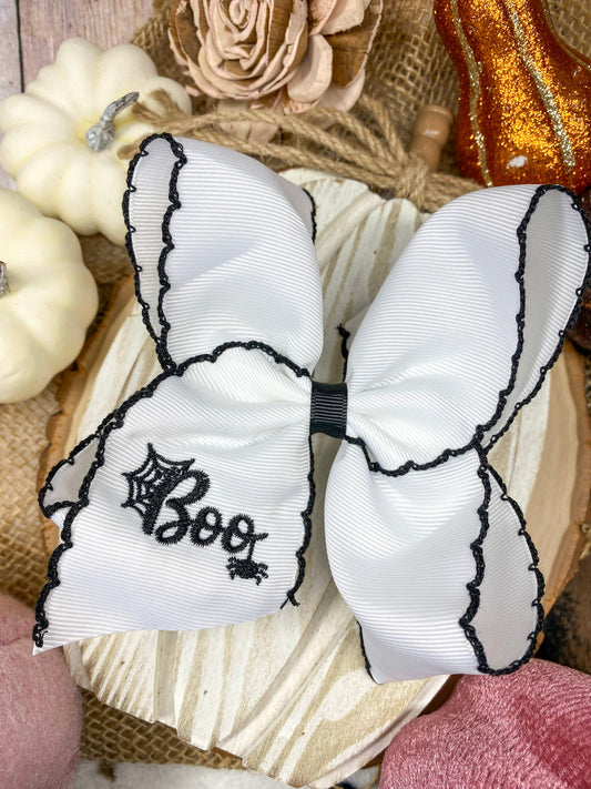 Black and White Boo Halloween Hair Bow on a wooden background