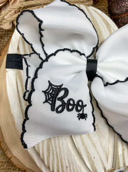 Black and White Boo Halloween Hair Bow on a wooden background