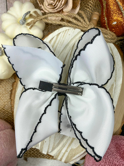 Black and White Boo Halloween Hair Bow on a wooden background