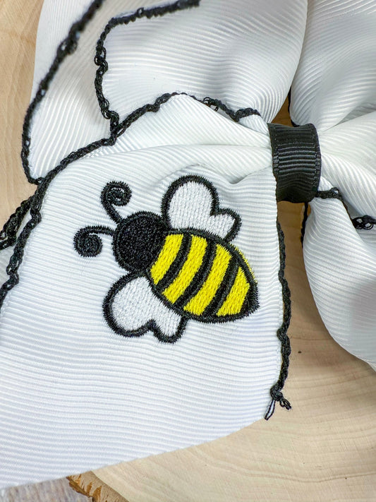 Close-up of bumblebee embroidery and moonstitch detail on hair bow - Alternative view