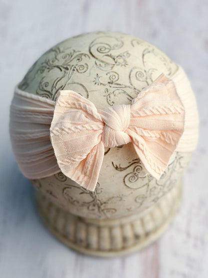 Light peach cable knit bow headband