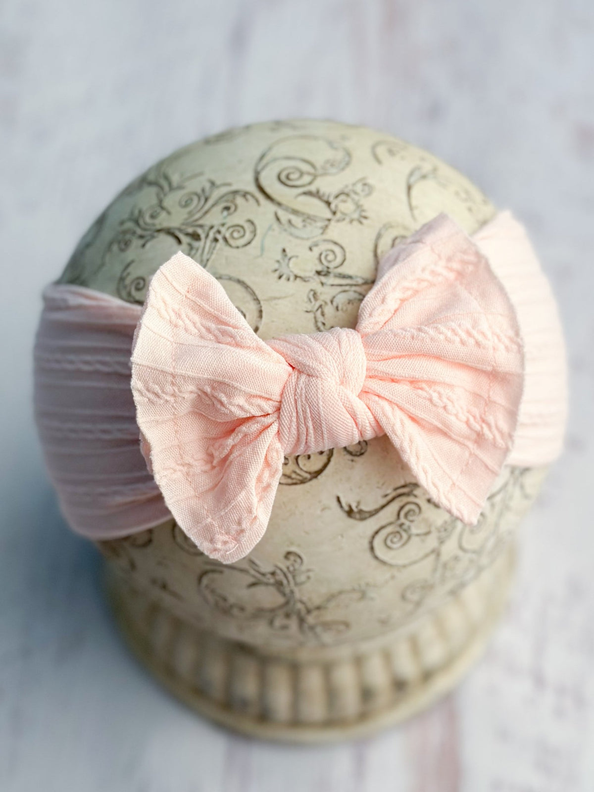 Light pink cable knit bow headband