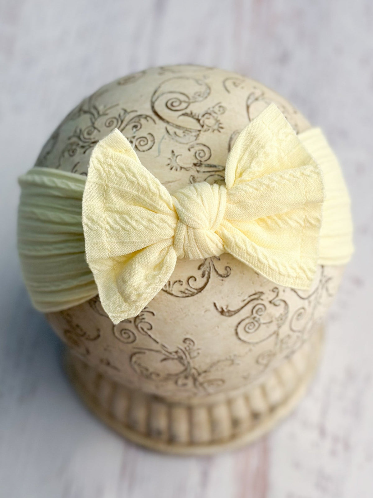 Light yellow cable knit bow headband