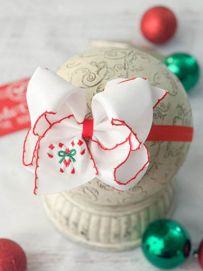 Candy cane embroidered bow on red satin headband