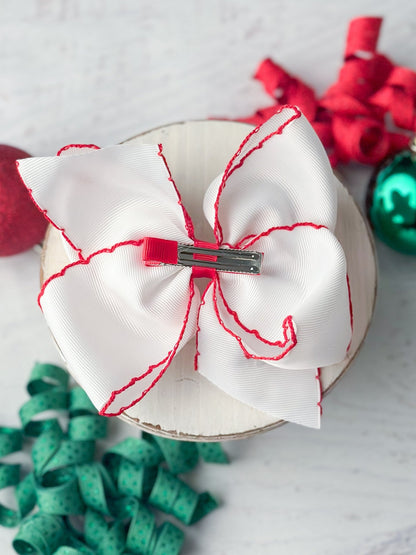 Back of candy cane embroidered hair bow showing alligator clip
