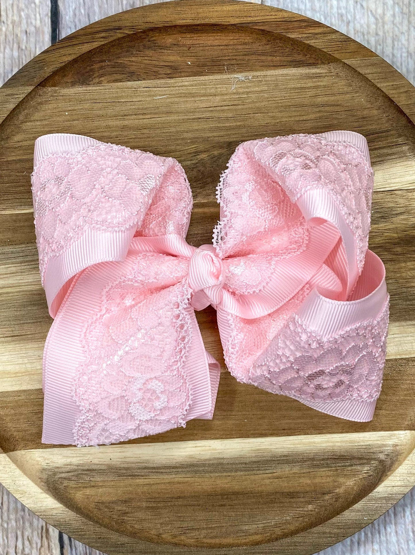 pink lace bow on wood