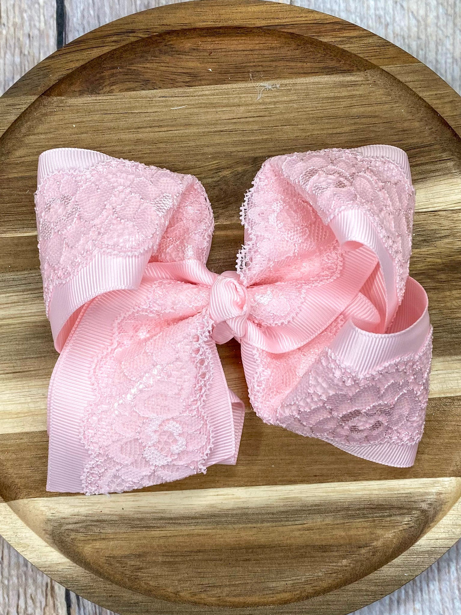 pink lace bow on wood