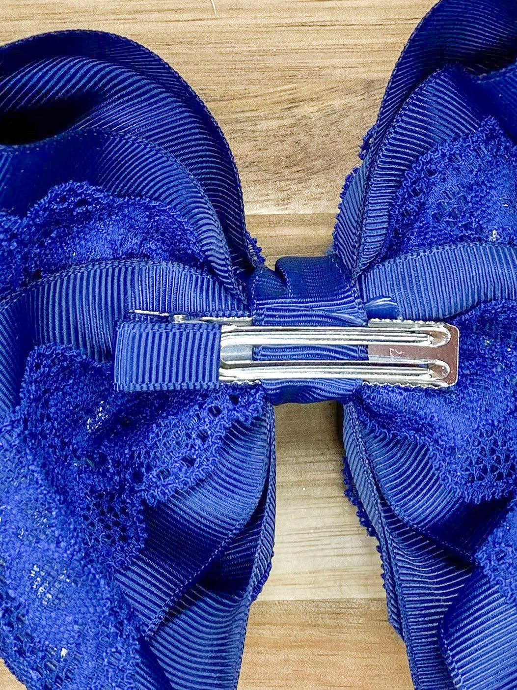  clip of lace bow on wood