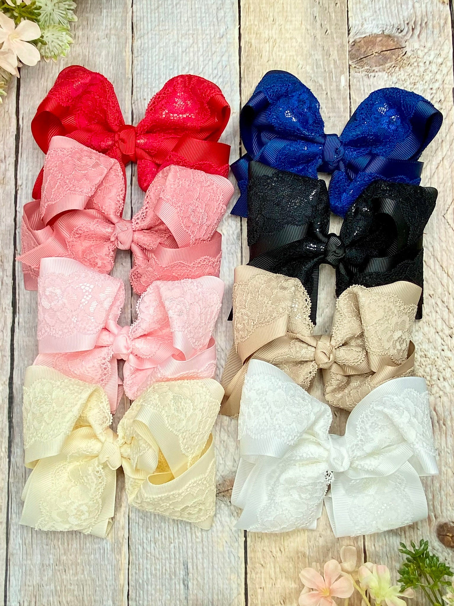 lace hair bows in assorted colors on background