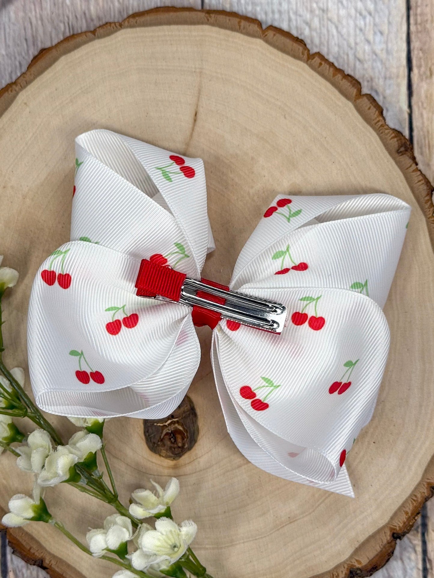 Back view of cherry print hair bow with silver alligator clip