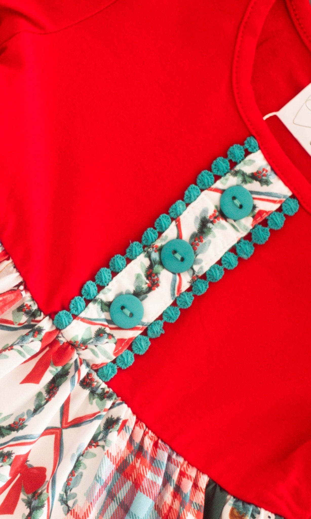 close up showing the decorative buttons on front of the dress