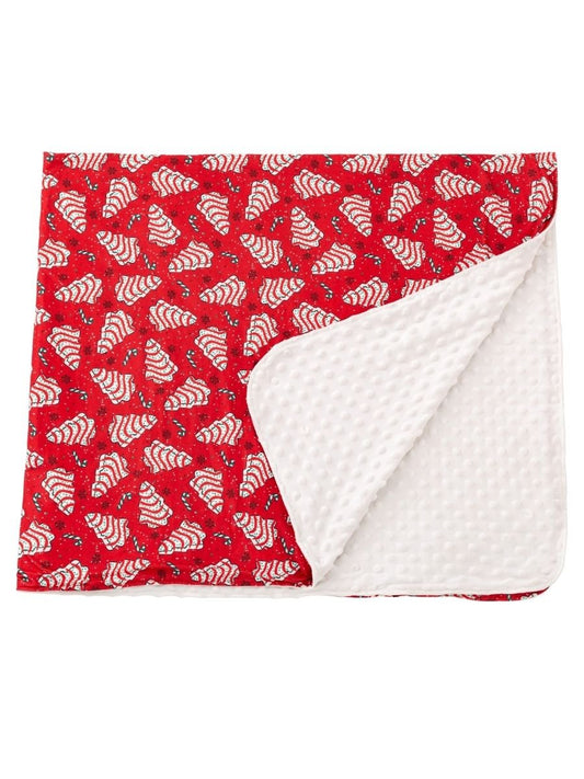 Christmas tree cake minky throw blanket with festive red holiday print and ultra-soft white dotted plush backing.