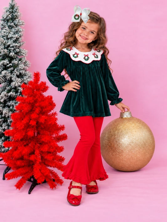 model wearing hunter green velvet girls top with embroidered wreath collar and red bell bottoms