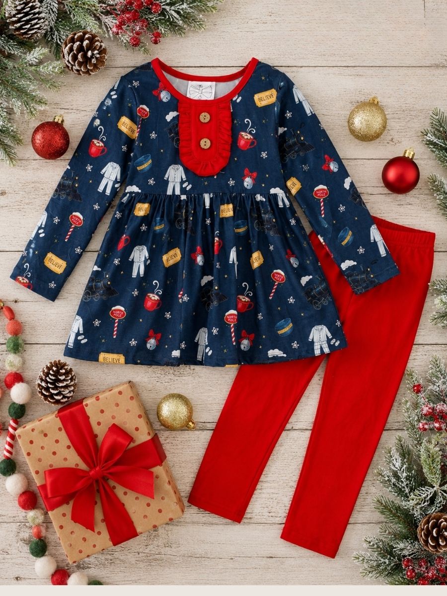 Girls Christmas train outfit flat lay with navy holiday print tunic, red leggings, wooden buttons, and festive boutique styling.
