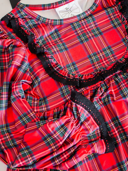 Red plaid dress with black trim on a white background