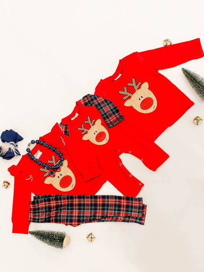 flat lay of a sibling set showing 3 outfits; far left is girls outfit with red long sleeve with a rudolf applique in the center paired with red and green plaid pants with a matching boy infant romper also red long sleeved with same rudolf applique in center and the red adnd green plaid sleeves and far right shows boys red long sleeve shirt with same rudolf applique