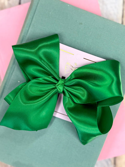 Green satin bow on a pink and green box