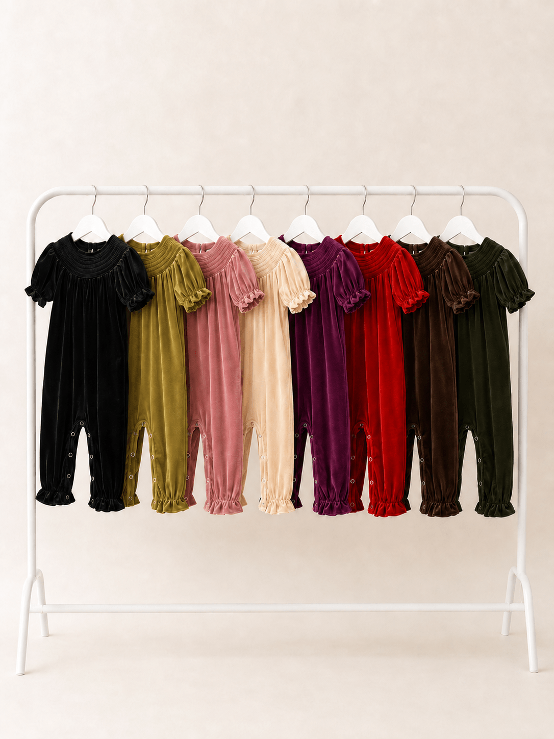 girls smocked velvet holiday rompers in 8 colors on clothing rack