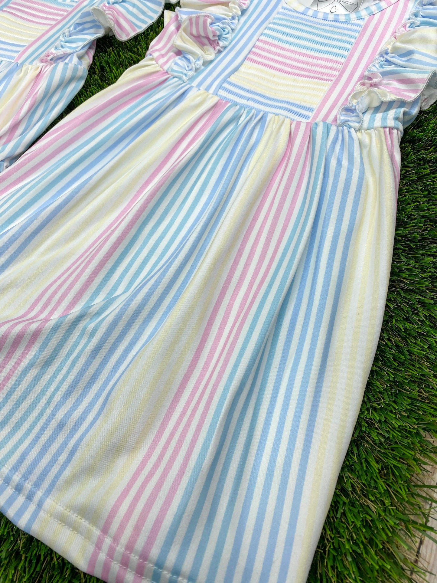 close up photo of pastel striped fabric from dress