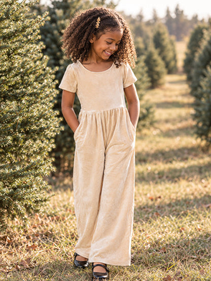 model wearing our cream velvet romper at a christmas tree farm