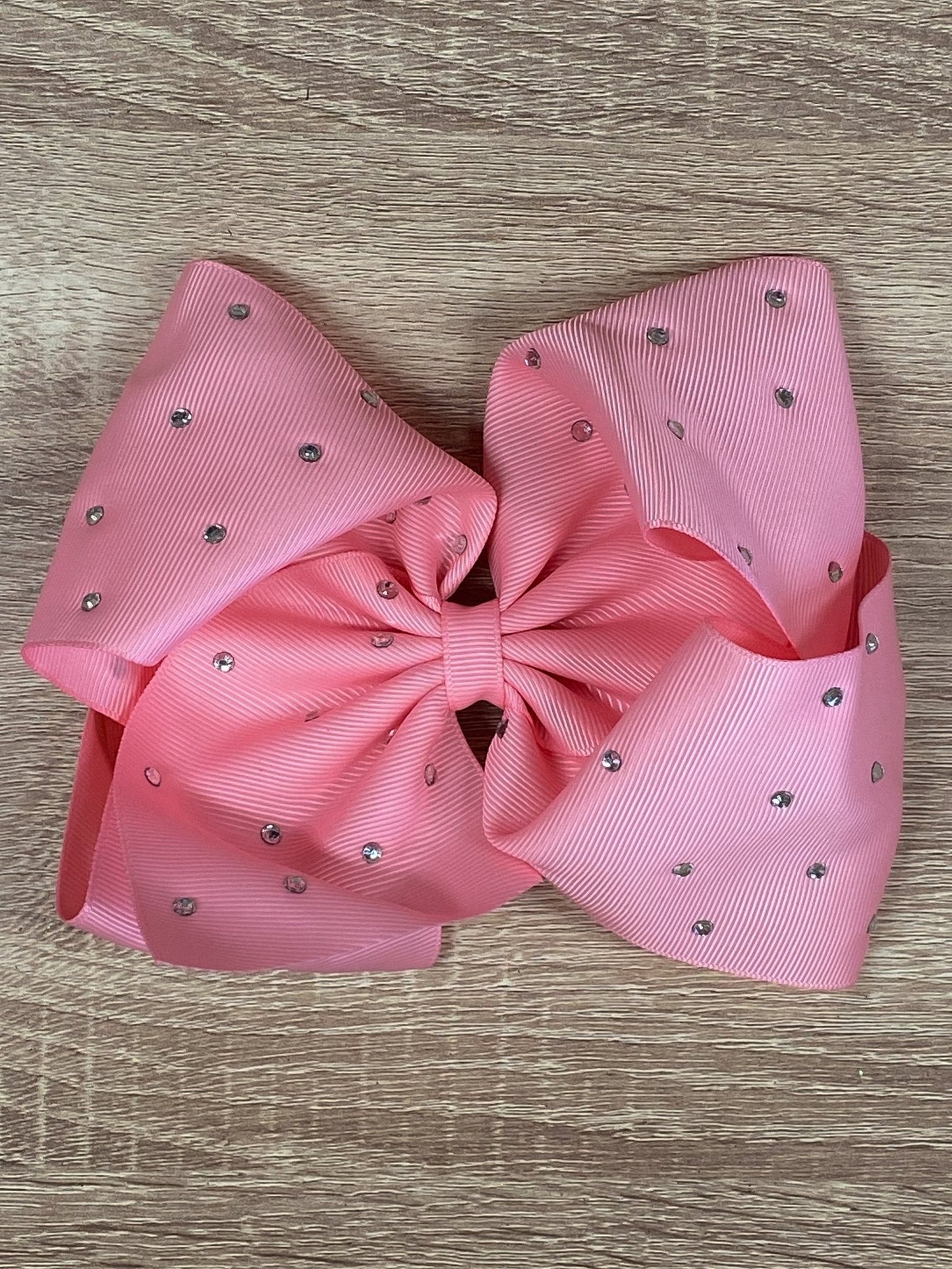 pink rhinestone hair bow on wood