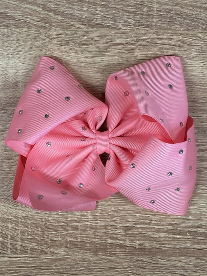 pink rhinestone hair bow on wood