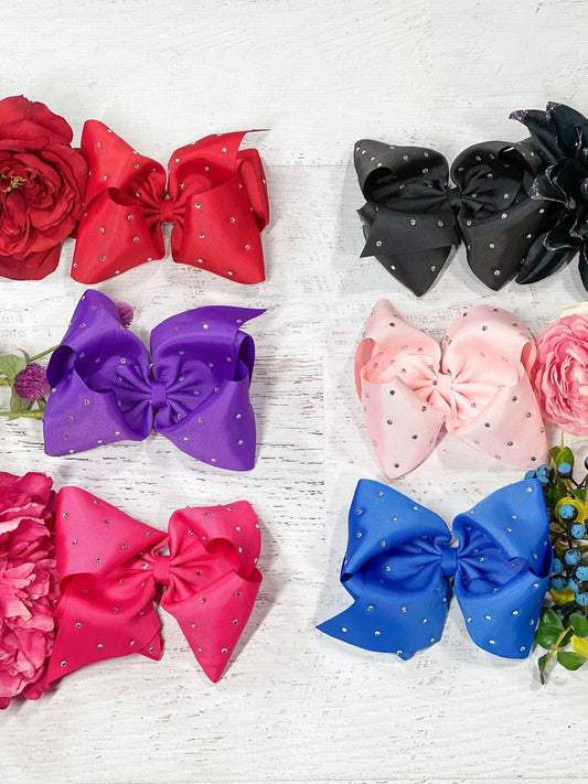 Texas size hair bows sprinkled with rhinestone embellishments! With 3" grosgrain ribbon, each bow measures about 7-8" across. These bows include a toothed style alligator clip to securely attach them. - Alternative view
